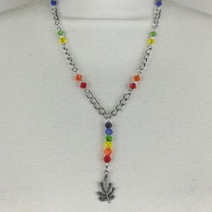 Unique and colorful Cannabis leaf theme necklace made with faceted glass beads